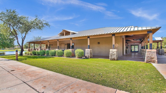3863 S Posse Trl, Gilbert, AZ 85297 - view of front facade featuring stucco siding, a front yard, a standing seam roof, and a metal roof