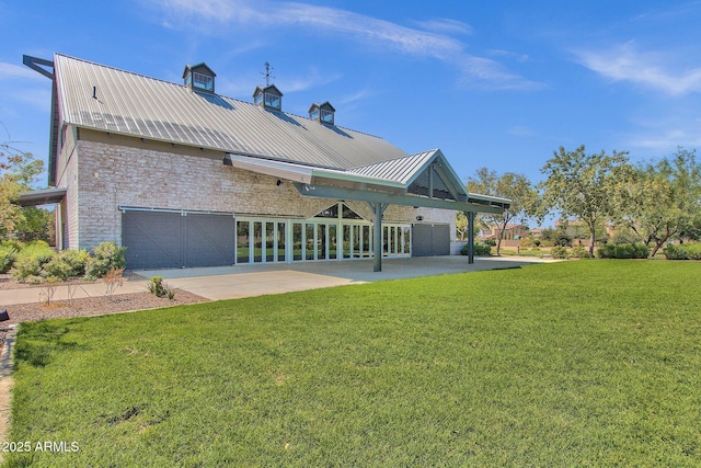 3863 S Posse Trl, Gilbert, AZ 85297 - back of property featuring a lawn, a metal roof, brick siding, and a garage