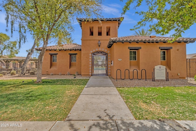 3863 S Posse Trl, Gilbert, AZ 85297 - mediterranean / spanish home featuring a tile roof, stucco siding, and a gate