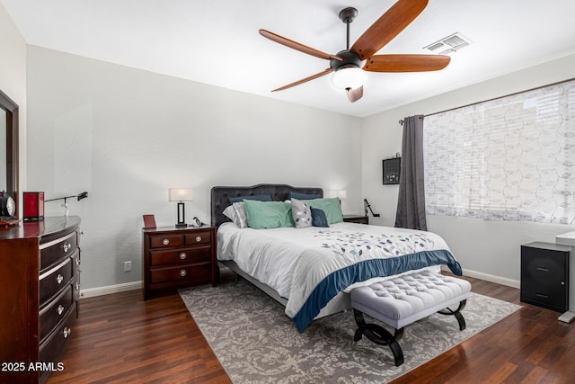 bedroom with dark wood-style floors, baseboards, visible vents, and a ceiling fan