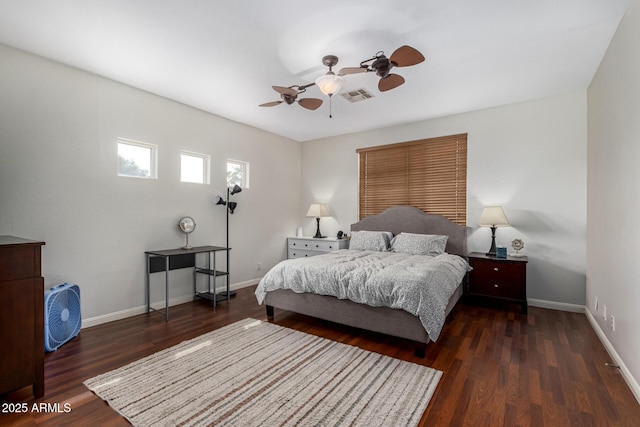 bedroom featuring a ceiling fan, wood finished floors, visible vents, and baseboards