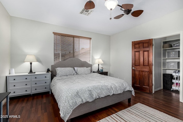 bedroom with wood finished floors, visible vents, and a ceiling fan