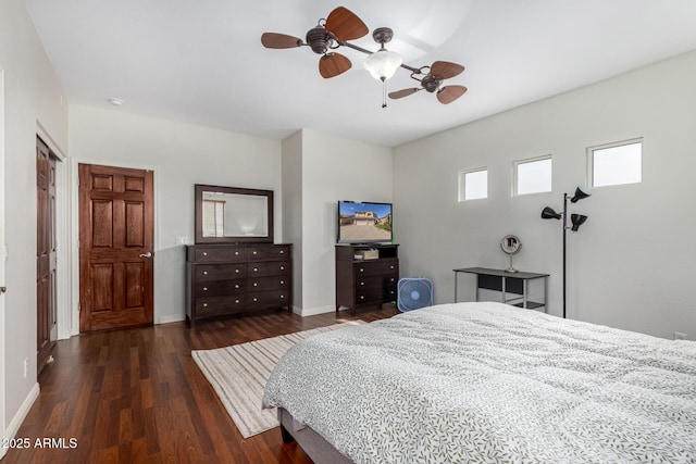 bedroom featuring ceiling fan, baseboards, and wood finished floors