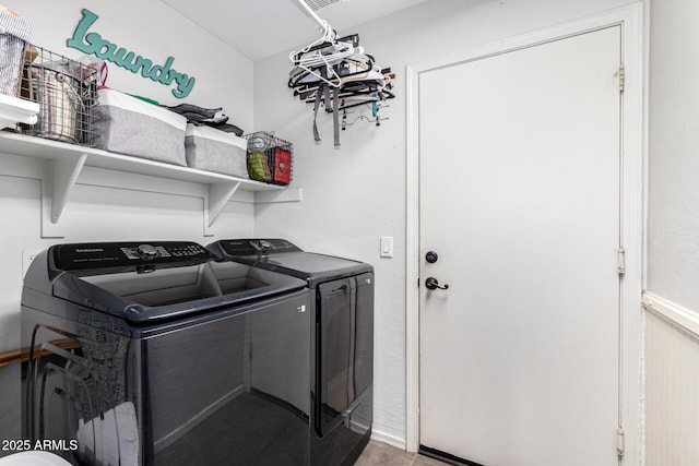 clothes washing area featuring washer and dryer and laundry area