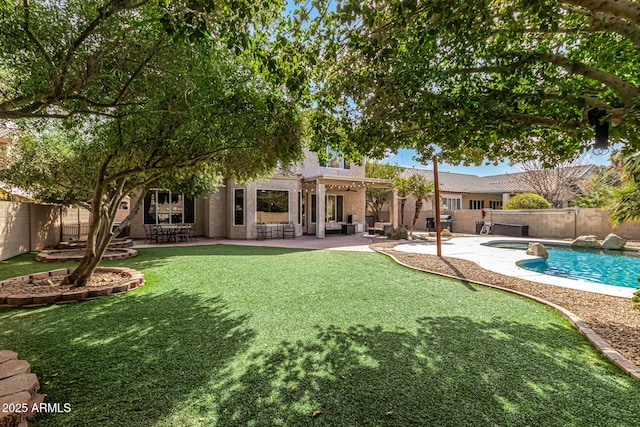 back of property with a fenced backyard, a lawn, a fenced in pool, and a patio