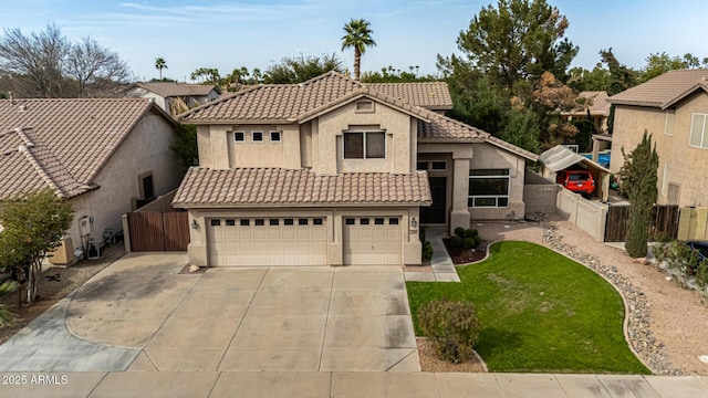 mediterranean / spanish-style house with a tiled roof, concrete driveway, fence, and stucco siding