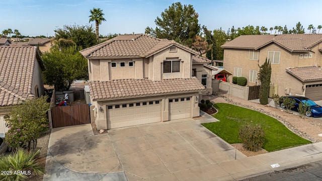 view of front facade featuring driveway, fence, a tile roof, and stucco siding