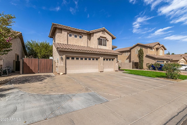 view of front facade featuring driveway, an attached garage, a gate, and stucco siding