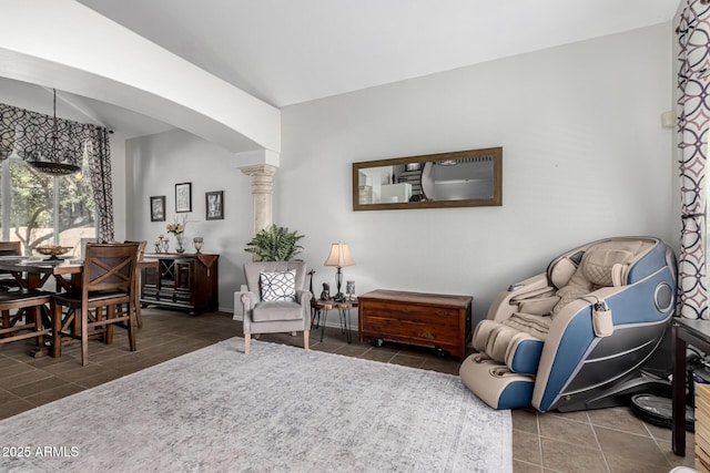 living area featuring decorative columns and tile patterned floors