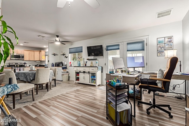 interior space featuring ceiling fan and light wood-type flooring