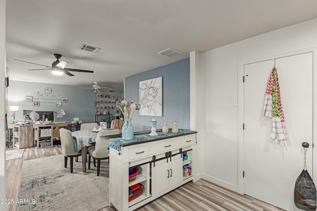 interior space featuring ceiling fan and light hardwood / wood-style flooring