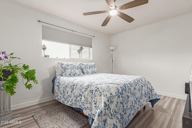 bedroom featuring hardwood / wood-style floors and ceiling fan