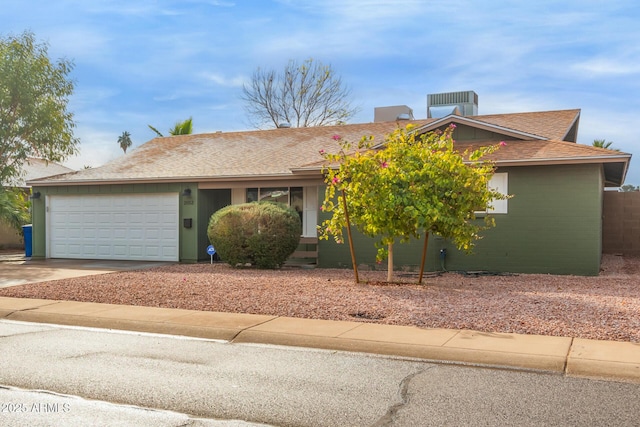 view of front of house with central AC unit and a garage