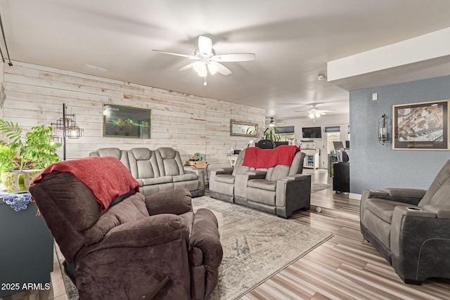 living room with light hardwood / wood-style flooring and ceiling fan