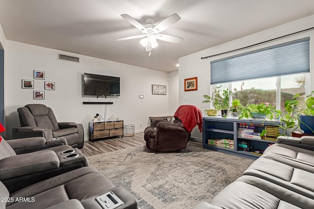 living room featuring ceiling fan and hardwood / wood-style floors