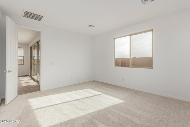 unfurnished room with light carpet