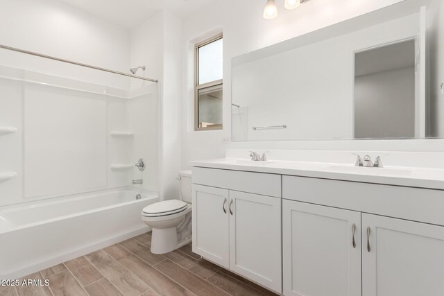 full bathroom featuring vanity, toilet, and washtub / shower combination