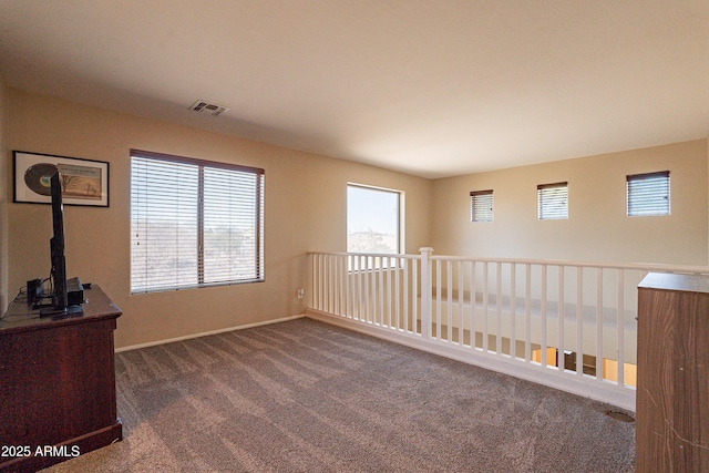 empty room featuring dark carpet