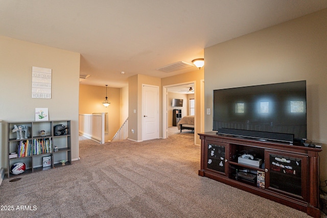 living room featuring carpet and ceiling fan