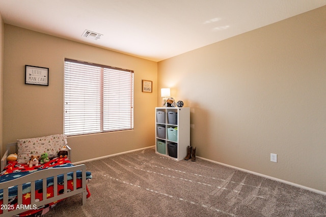 sitting room featuring dark carpet