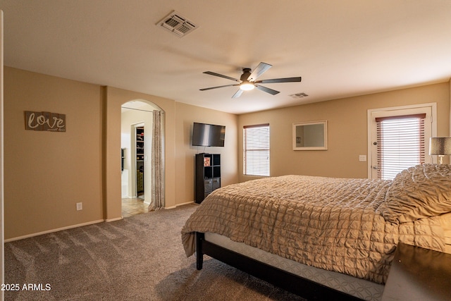 bedroom with multiple windows, carpet floors, and ceiling fan