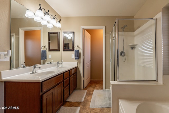 bathroom featuring tile patterned floors, vanity, and a shower with shower door