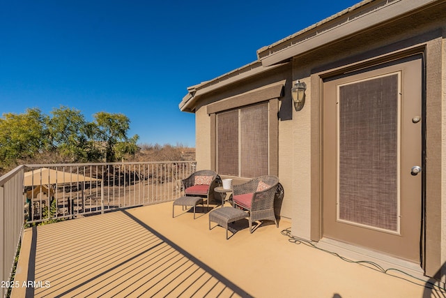 view of patio featuring a balcony