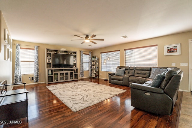 living room with ceiling fan and dark hardwood / wood-style floors