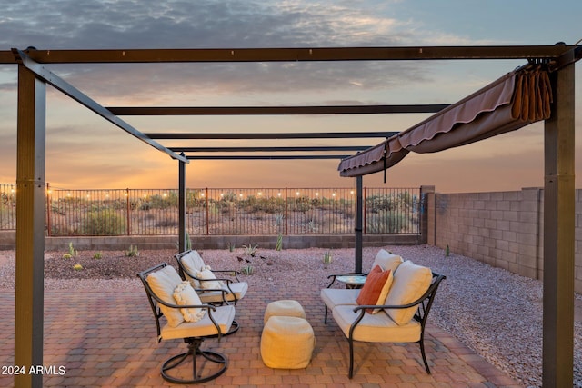 patio terrace at dusk with a fenced backyard