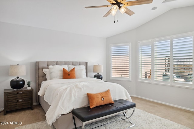 bedroom with light carpet, vaulted ceiling, baseboards, and ceiling fan