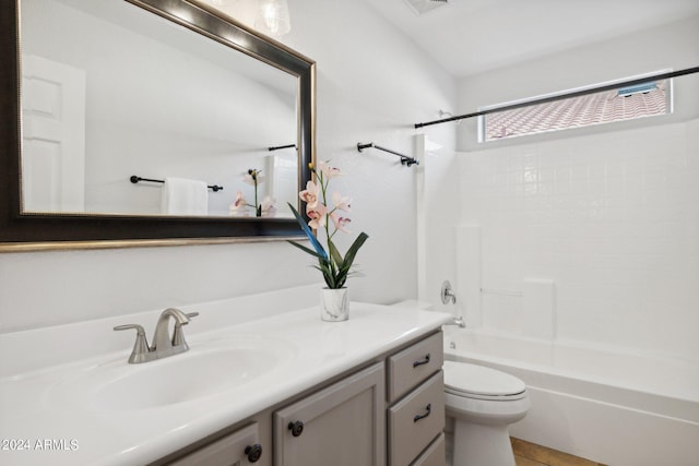 bathroom featuring vanity, toilet, and shower / bathtub combination