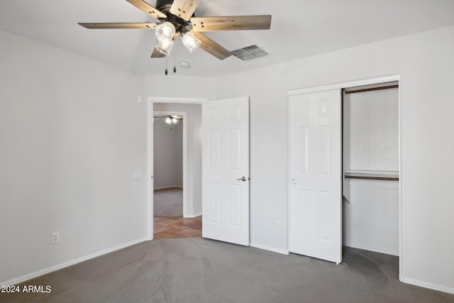 unfurnished bedroom featuring carpet flooring, a closet, baseboards, and ceiling fan