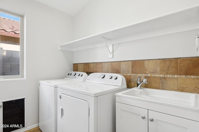 laundry room with washing machine and dryer and cabinet space