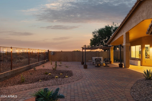 yard at dusk with a patio and a fenced backyard