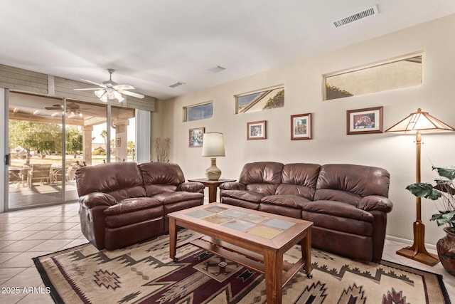 tiled living room with ceiling fan