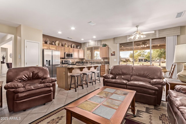 living room featuring ceiling fan and light tile patterned floors