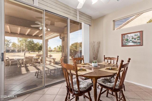 tiled dining room featuring ceiling fan