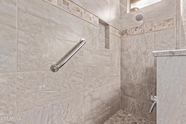 bathroom with tiled shower