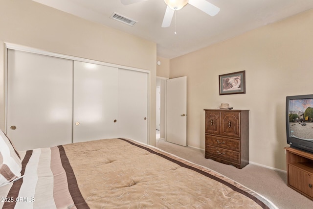 bedroom with a closet, ceiling fan, and carpet flooring