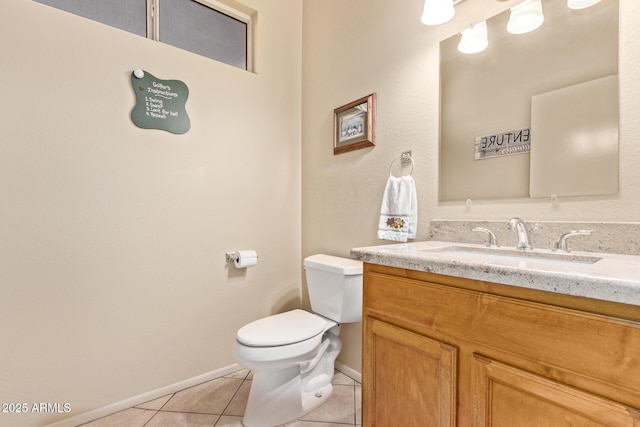 bathroom featuring vanity, tile patterned floors, and toilet