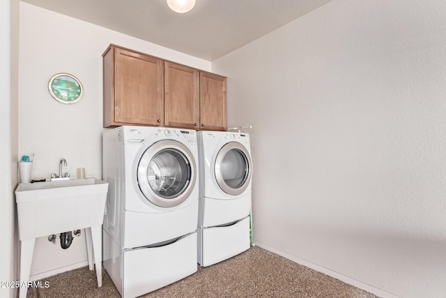 washroom with washing machine and dryer and cabinets