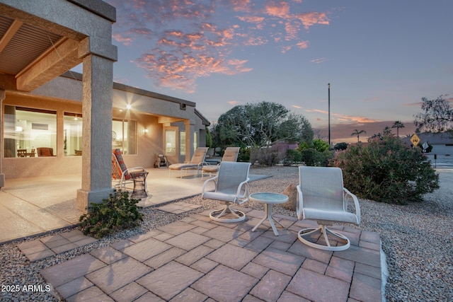 view of patio terrace at dusk