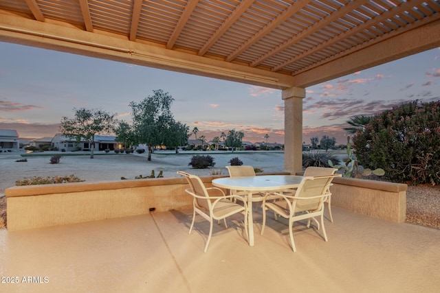 patio terrace at dusk with a pergola