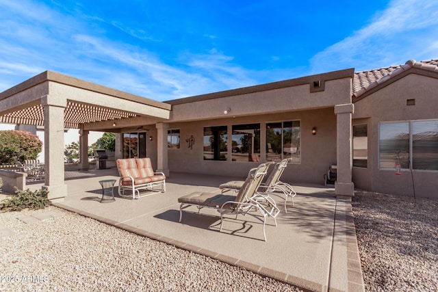 rear view of house with a pergola and a patio