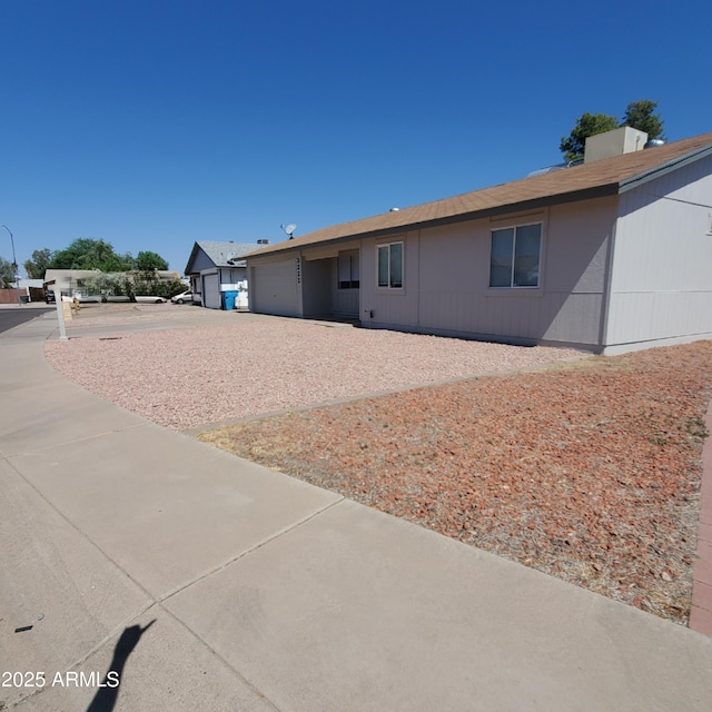 3222 W Wagoner Rd, Phoenix, AZ 85053 - back of house featuring an attached garage and driveway