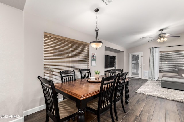 dining area with ceiling fan, lofted ceiling, and dark hardwood / wood-style floors