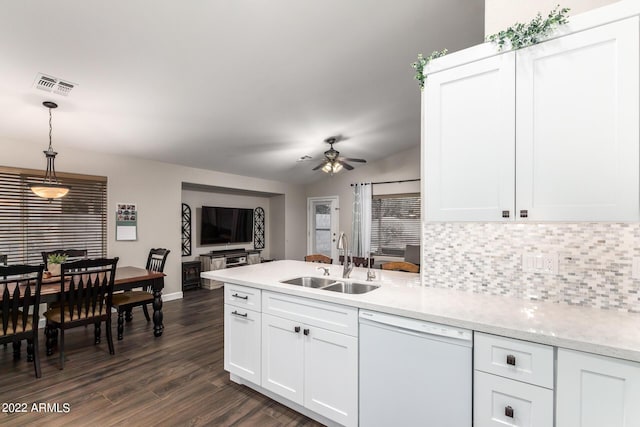 kitchen with white dishwasher, sink, pendant lighting, and white cabinets