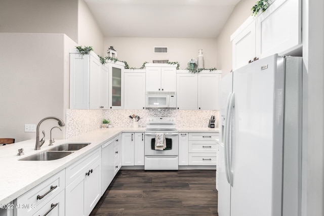 kitchen featuring sink, tasteful backsplash, dark hardwood / wood-style flooring, white appliances, and white cabinets