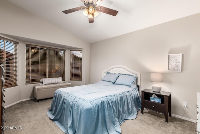 carpeted bedroom with vaulted ceiling and ceiling fan