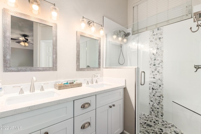 bathroom with vanity, an enclosed shower, and ceiling fan